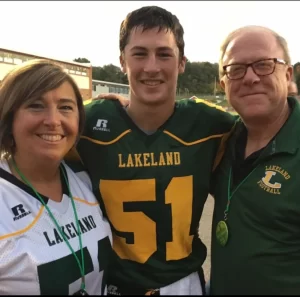 kevin moore tom thumb graduate at high school game with parents